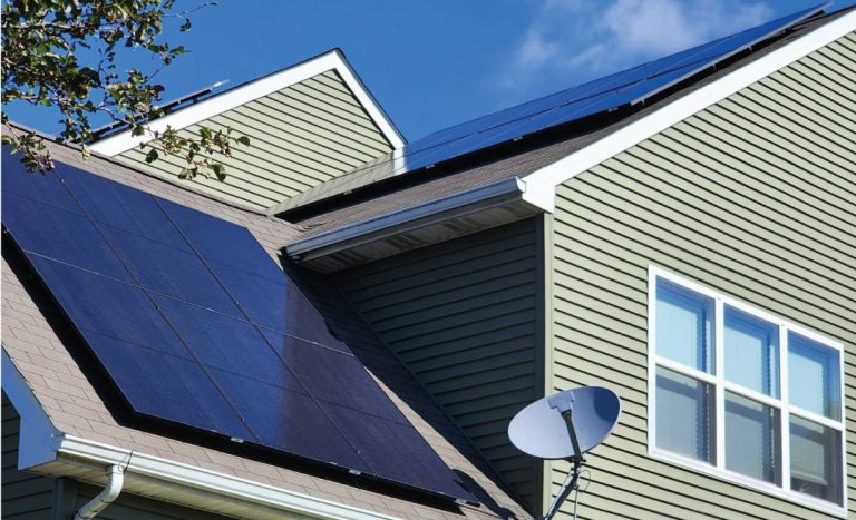 Sleek, black solar panels integrated into a modern multi-gabled roof, highlighting Cosmo Solaris’s ability to provide turnkey installations and roofing repairs for a seamless aesthetic.