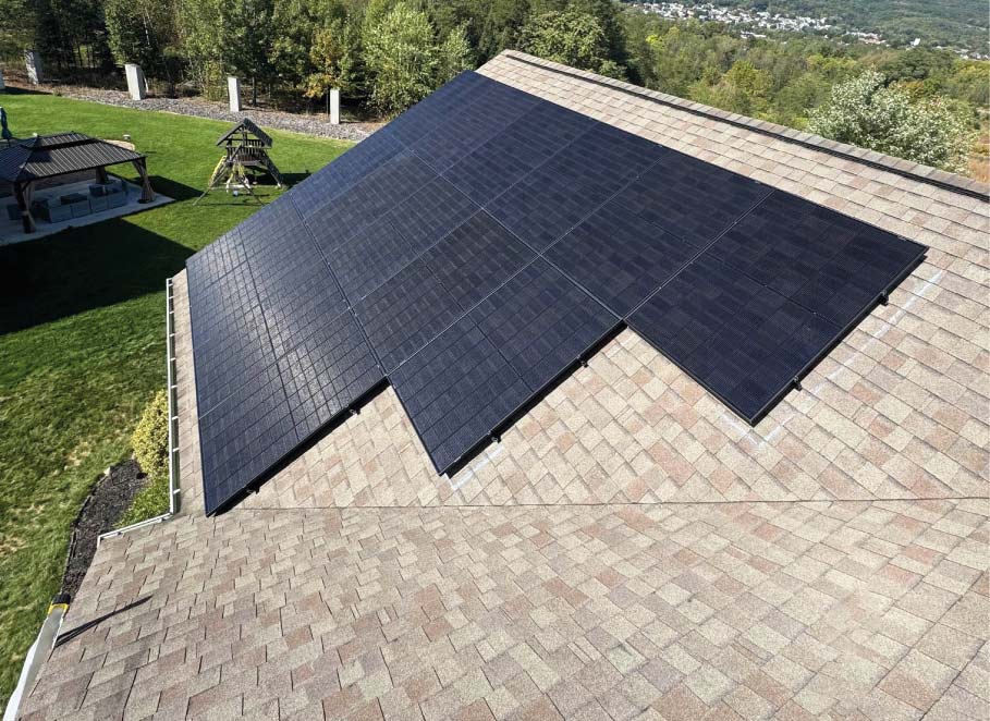 A high-efficiency solar panel array expertly integrated into a residential shingle roof by Cosmo Solaris, optimized for maximum sun exposure and backed by a 30-year performance warranty.