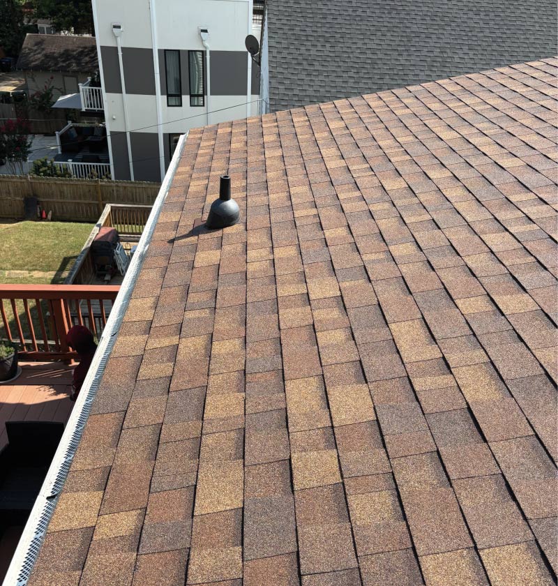 Close-up of a clean, professionally installed shingle roof by Cosmo Solaris, prepared for a high-efficiency solar array as part of a turnkey energy solution.